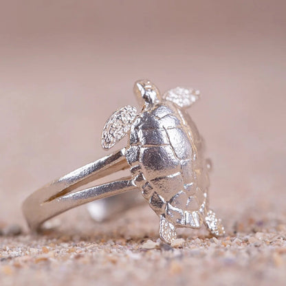Anillo de Tortuga (Cayume) en Plata de perfil con fondo de arena.